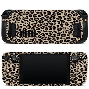 May include: Two handheld gaming consoles with a leopard print design. The top console is viewed from the back, and the bottom console is viewed from the front, showing the screen and controls. The leopard print features tan and brown spots.