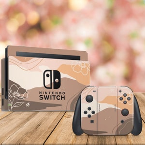 May include: A Nintendo Switch console and controller with a custom skin featuring an abstract design in shades of brown, beige, and white. The design includes stylized flowers and the text "Nintendo Switch".