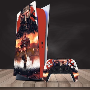 May include: A red and black video game console with a custom design featuring a samurai warrior and a Japanese castle. The console is next to a matching video game controller with a similar design.