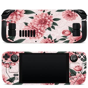 May include: A handheld gaming console featuring a floral skin with large pink dahlia flowers and dark green leaves on a light pink background. The device includes a black screen, black buttons, joysticks, and a directional pad on the front.