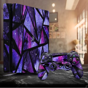 May include: A purple and black PlayStation 4 console and controller with a geometric pattern inspired by outer space.