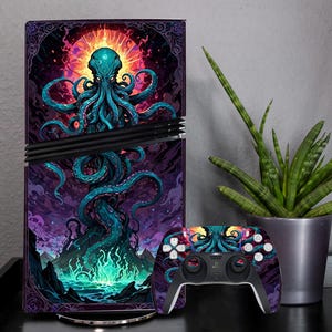 May include: A games console and controller set with an octopus design. The console has a purple, blue, and orange graphic. The controller has a matching design with white buttons. A potted snake plant is to the right.