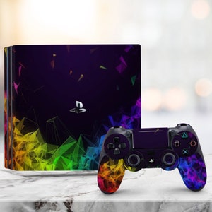 May include: A PlayStation 4 console and controller set with a vibrant geometric design. The console and controller feature a dark purple background with colorful triangular shapes in shades of yellow, green, blue, and purple.