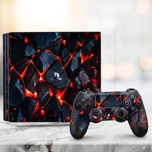 May include: A black and red PlayStation 5 console and controller with a lava rock design. The console is a rectangular box with a textured surface. The controller has a textured surface and a black and red design.