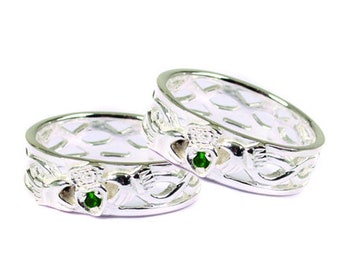 May include: Two silver Celtic knot rings with green gemstones. The rings are intertwined and feature a traditional Claddagh design.