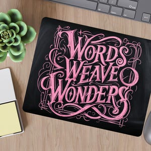 May include: Black background with pink lettering that reads "Words Weave Wonders". The lettering is in a decorative, stylized font.