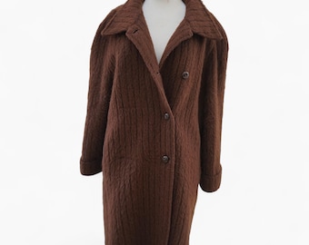 May include: A brown, textured coat with a classic design. The coat features a notched collar, two rows of buttons, and long sleeves. The coat is displayed on a mannequin against a white background.