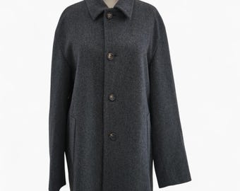 May include: A charcoal gray coat with a classic collar and three buttons. The coat has two front pockets and long sleeves. The coat is displayed on a mannequin.