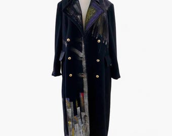 May include: A long black double-breasted coat with gold buttons and an abstract painting on the front.