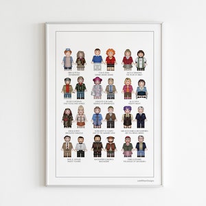 May include: A white framed print with a white background and 20 pairs of Lego minifigures. Each pair is labelled with the names of a famous couple. The print is titled "Lovebirds Designs".