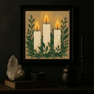 May include: A framed art print featuring three white candles with orange flames, surrounded by green leaves. The artwork has a warm, inviting color palette and is set against a neutral background. The black frame adds a touch of elegance.
