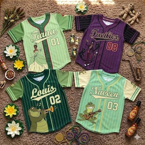 May include: Four baseball jerseys with character designs from a movie. The jerseys are green, purple, and yellow with character names and numbers. One jersey has a princess, another has a villain, and the other two have an alligator and a frog.