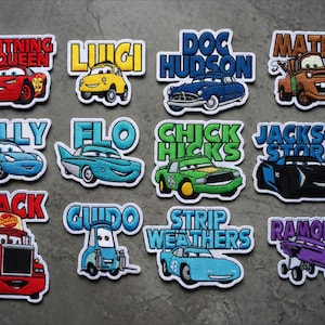 May include: A selection of embroidered patches showcasing characters from the film "Cars." Each patch features a car character's name in a vibrant font, alongside the car's image. Characters include Lightning McQueen, Mater, and Doc Hudson.