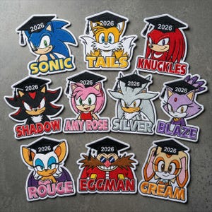 May include: A collection of embroidered patches featuring characters from the Sonic the Hedgehog franchise, each wearing a graduation cap with "2026" on it. Characters include Sonic, Tails, Knuckles, Shadow, Amy Rose, Silver, Blaze, Rouge, Eggman, and Cream.