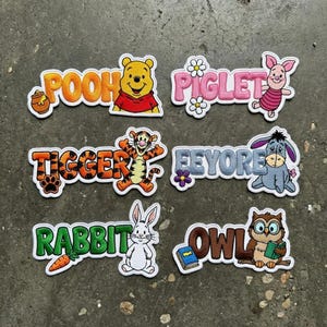 May include: A rustic wooden sign with the text "Welcome to our home" in a handwritten style. The sign features a distressed finish and a simple, inviting design, perfect for a front porch or entryway.