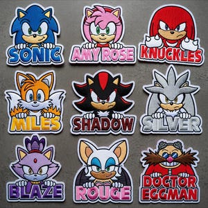 May include: A white ceramic mug with a black handle and the text "But First, Coffee" in a bold, black font. The mug is set against a blurred background, suggesting a cozy setting.