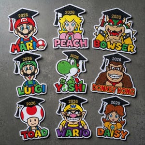 May include: A set of three ceramic mugs with a speckled, matte finish. The mugs are in shades of cream, light gray, and dark gray. Each mug has a simple, minimalist design and a rounded handle.