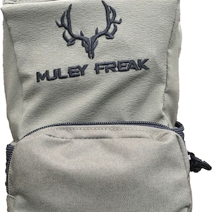 May include: A green canvas bag with a black zipper and a black handle. The bag has a black embroidered logo that says "MULEY FREAK" and a black embroidered image of a deer skull with antlers.
