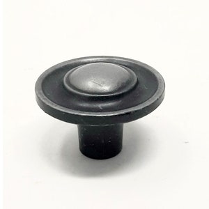 May include: A silver-toned metal cabinet knob with a round, raised top and a flat base.