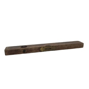 May include: A vintage wooden level with a brass level indicator. The level is brown and has two holes on the top.