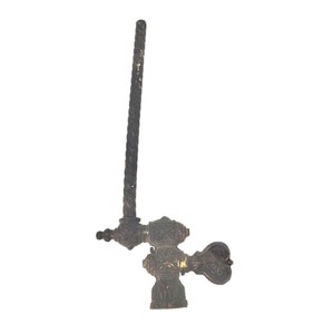 以下が含まれることがあります： 装飾的なハンドルと長いテクスチャード加工のステムを備えた、アンティークのブロンズ製の蛇口。 蛇口には複雑な花柄と幾何学模様があり、暗く古びた仕上がりです。 ハンドルはハート型です。