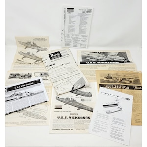 May include: A collection of vintage model ship building kits, including the USS Pine Island, USS Vicksburg, USS Yorktown, USS Intrepid, and a passenger liner. The kits are from the brands Lindberg and Revell.