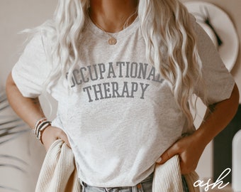 May include: A heather grey t-shirt with the text "OCCUPATIONAL THERAPY" printed in grey on the front.