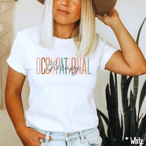 May include: White t-shirt with the text "OCCUPATIONAL therapy" in colorful letters.