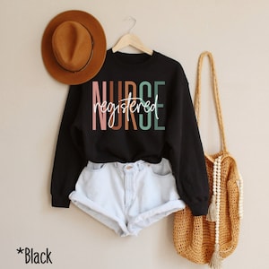 May include: Black sweatshirt with the text "registered nurse" in colorful letters.