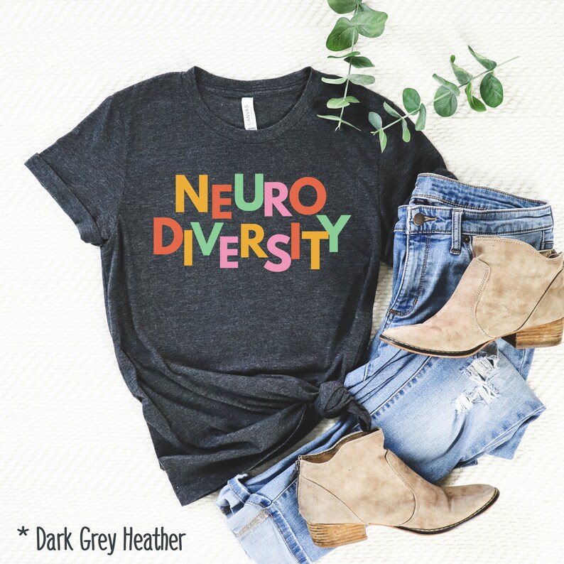 May include: Dark grey heather t-shirt with the text "NEURODIVERSITY" in colorful block letters.