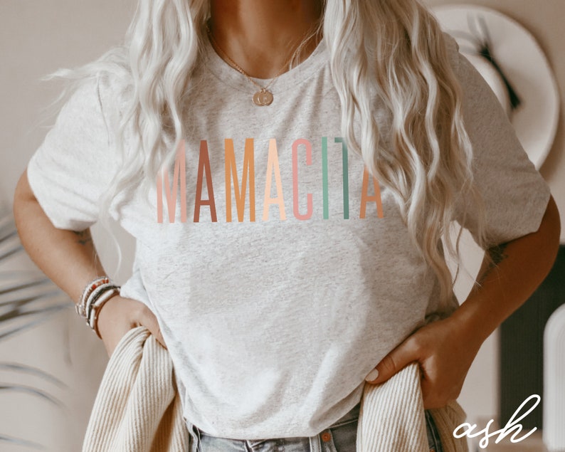 May include: A gray t-shirt with the word "MAMACITA" printed in rainbow colors.