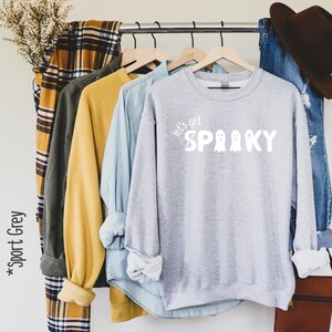 May include: A gray sweatshirt with the text "Let's get spooky" in white with three ghost illustrations.
