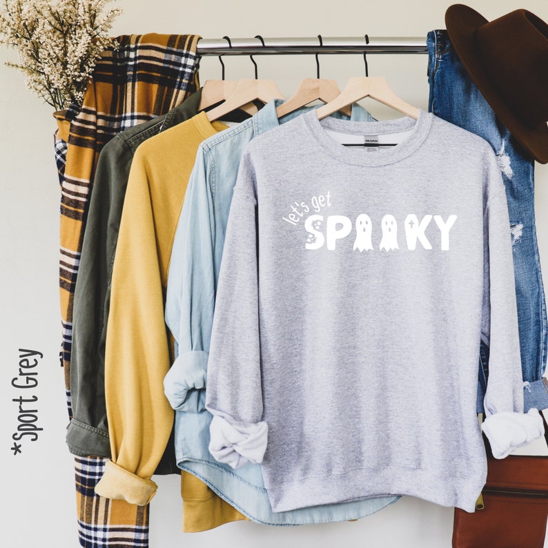May include: A gray sweatshirt with the text "Let's get spooky" in white with three ghost illustrations.