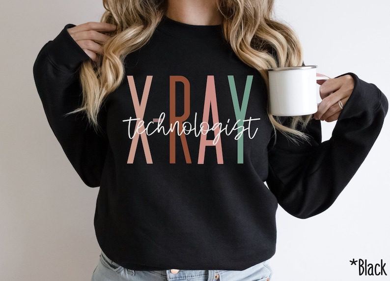May include: Black sweatshirt with the text "X-RAY technologist" in colourful letters. The letters are in shades of pink, brown, and green.