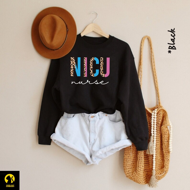 May include: Black sweatshirt with the words "NICU nurse" in colorful letters with a leopard print design.
