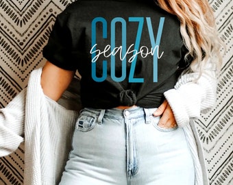May include: A black t-shirt with a blue and white graphic that says "cozy season".