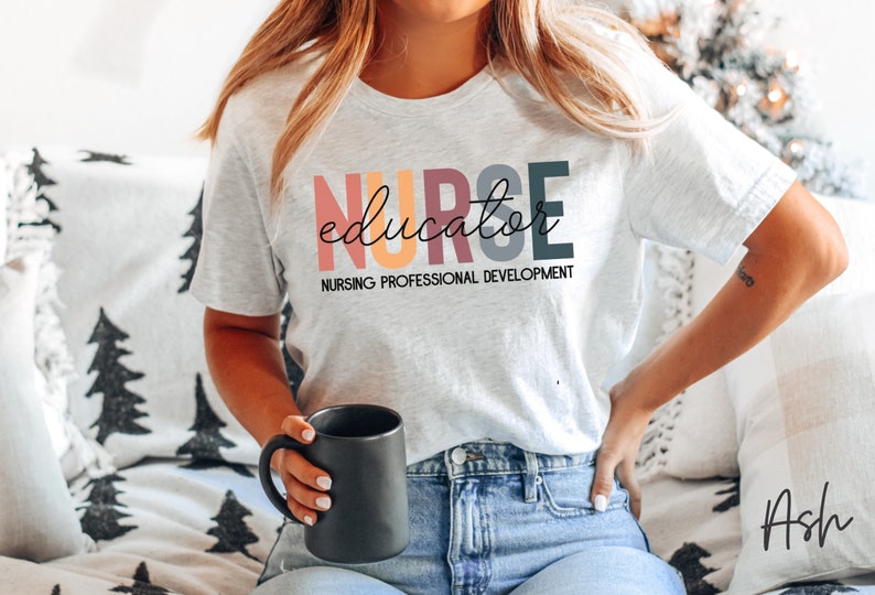 May include: A gray t-shirt with the text "NURSE educator" in colorful letters. The text "NURSING PROFESSIONAL DEVELOPMENT" is printed below the main text.