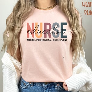 May include: A heather peach colored t-shirt with the text "NURSE educator" in colorful block letters. The text "NURSING PROFESSIONAL DEVELOPMENT" is printed below the main text.