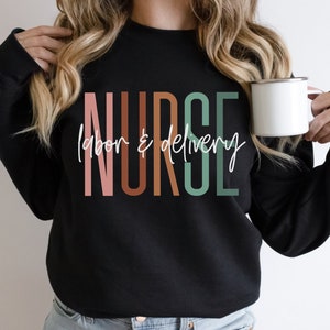 May include: Black sweatshirt with the text "NURSE labor & delivery" in colorful vertical letters.