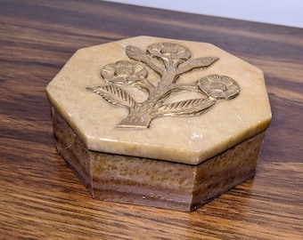 May include: Octagonal shaped, beige stone trinket box with a gold floral design on the lid.