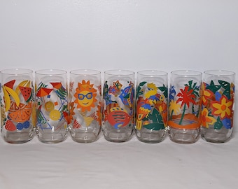 May include: Set of six clear glass tumblers with colorful summer-themed designs. The designs include a sun with sunglasses, tropical birds, palm trees, and fruit.