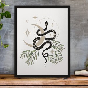 May include: A black snake wrapped around a crescent moon with a dotted circle and stars around it. The snake is surrounded by green leaves.
