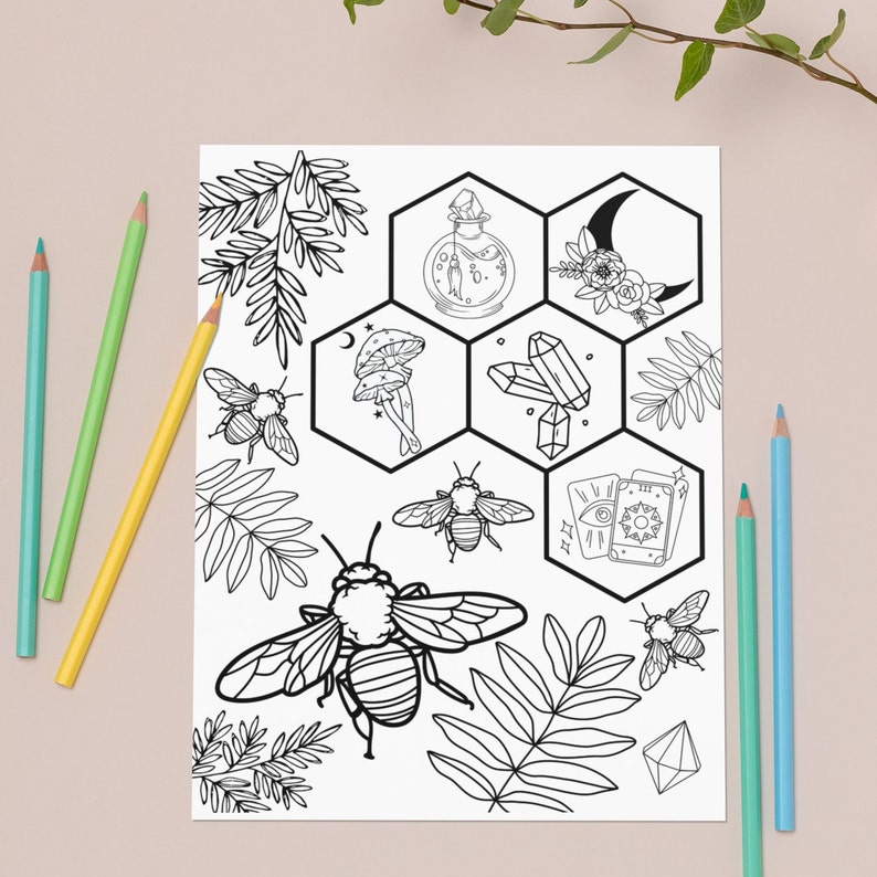 May include: Black and white coloring page featuring a honeycomb design with various illustrations including bees, crystals, mushrooms, a potion bottle, tarot cards, and a crescent moon.