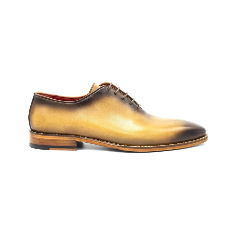 May include: A pair of brown leather lace-up shoes with a yellow ombre effect. The shoes have a brown leather sole and a black rubber heel.