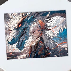 May include: A white-haired anime character with blue eyes and a red and white patterned outfit stands in front of a large blue dragon with red eyes. The dragon's wings are spread out behind the character.
