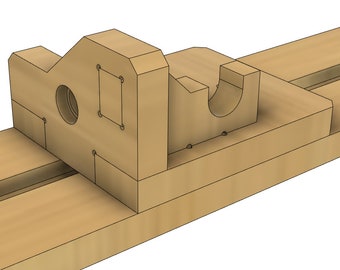 May include: A wooden jig with a round hole and a slot for holding a piece of wood. The jig is designed to help with woodworking projects.