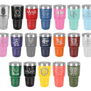 May include: Twenty-four stainless steel tumblers with various colors and designs. Each tumbler features a unique engraved design, including logos, text, and images. The tumblers are all the same size and shape, with a double-walled construction and a lid.