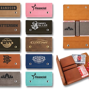 May include: A set of ten different card holders, each with a different design. The card holders are made of brown leather and have a flap that closes with a snap. The designs include a star, a logo, a house, a car, a fish, a tent, and a name. The card holders are all in a row on a white background.