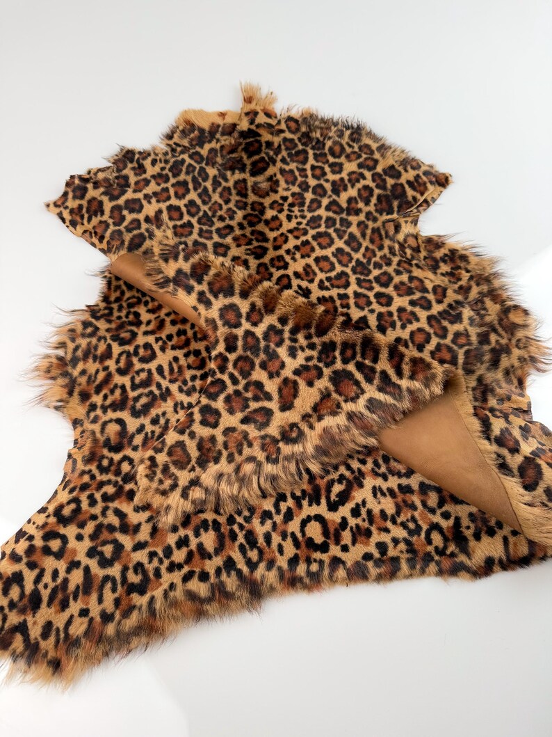 May include: A brown and black leopard print faux fur rug with a soft, fluffy texture.