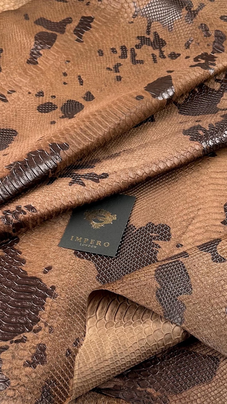 Unique hair-on calf hide with an exotic snakeskin-style print in brown and black tones, ideal for sneaker designers and luxury leather accessories